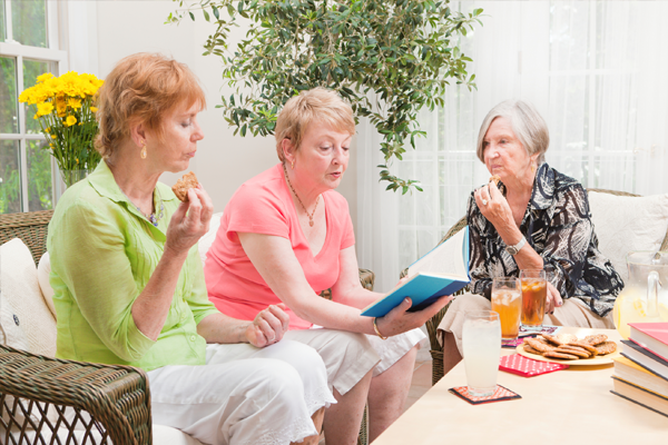 3 women looking at a document